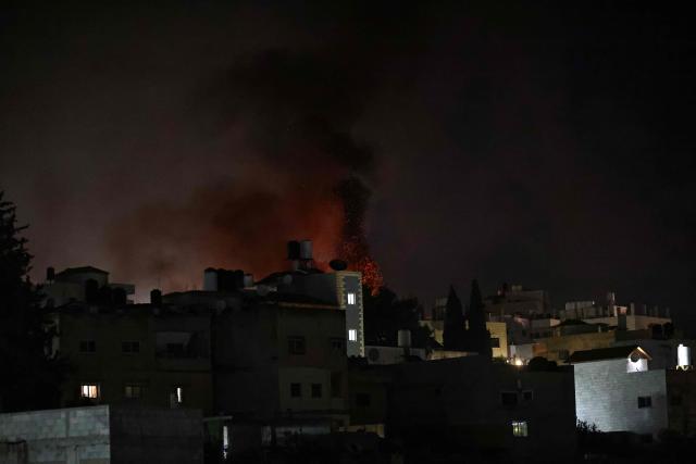 Flame and smoke rises from burning houses and vehicles following a reported attack by Israeli settlers in the village of Deir al-Hatab, east of Nablus in the occupied West Bank on March 22, 2026. Violence more broadly in the West Bank, which Israel has occupied since 1967, has risen sharply since the October 7, 2023 Hamas attack on Israel triggered the Gaza war. It has continued despite a ceasefire in place since October 10. (Photo by Zain JAAFAR / AFP)