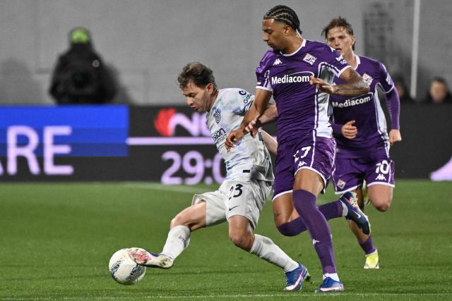 Inter Milan's Italian midfielder #23 Nicolo Barella fights for the ball with Fiorentina's Italian midfielder #27 Cher N'Dour during the Italian Serie A football match between Fiorentina and Inter Milan at the Artemio Franchi Stadium in Florence on March 22, 2026. (Photo by Tiziana FABI / AFP)