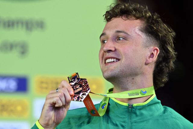 Bronze medallist Australia's Adam Spencer celebrates on the podium for the men's 1500m event during the World Athletics Indoor Championships Kujawy Pomorze 2026 in Torun, Poland on March 22, 2026. (Photo by Kirill KUDRYAVTSEV / AFP)