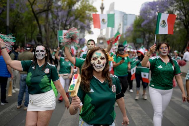 People take part in a procession of Catrinas wearing the Mexican World Cup national football team jersey in Mexico City on March 22, 2026. (Photo by Alfredo ESTRELLA / AFP)