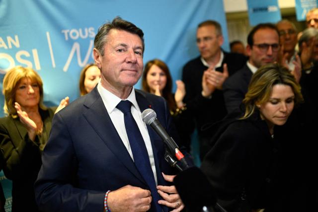 Nice's incumbent mayor and Horizons and Les Republicains (LR) candidate for re-election Christian Estrosi, next to his wife Laura Tenoudji-Estrosi, delivers a speech at the party's rally following the results of the second round of France's 2026 municipal elections in Nice, southeastern France on March 22, 2026. (Photo by Frederic DIDES / AFP)