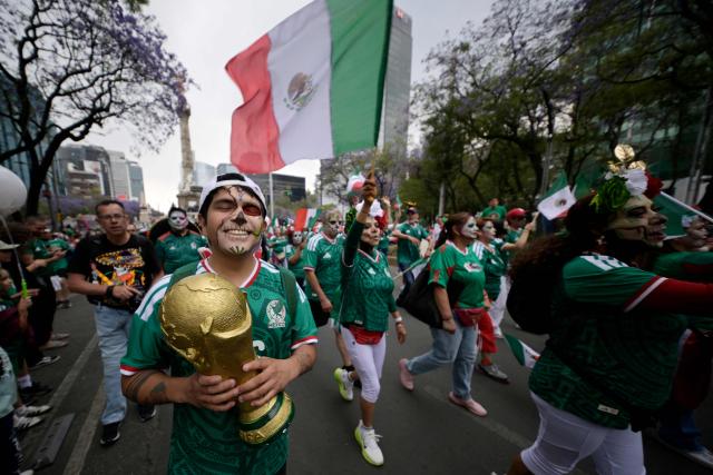 People take part in a procession of Catrinas wearing the Mexican World Cup national football team jersey in Mexico City on March 22, 2026. (Photo by Alfredo ESTRELLA / AFP)