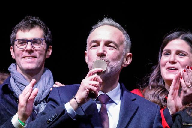 Socialist Party (PS) Member of Parliament and left wing Paris mayoral candidate Emmanuel Gregoire kisses the key to the Paris city hall   during a gathering following the second round of France's 2026 municipal elections in Paris on March 22, 2026. Gregoire was elected Paris mayor in the French capital's municipal elections. (Photo by GEOFFROY VAN DER HASSELT / AFP)