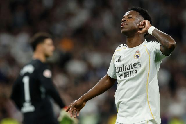 Real Madrid's Brazilian forward #07 Vinicius Junior celebrates scoring his team's third goal during the Spanish league football match between Real Madrid CF and Club Atletico de Madrid at Santiago Bernabeu Stadium in Madrid on March 22, 2026. (Photo by Oscar DEL POZO / AFP)