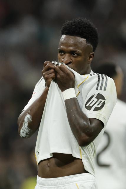 Real Madrid's Brazilian forward #07 Vinicius Junior celebrates scoring his team's third goal during the Spanish league football match between Real Madrid CF and Club Atletico de Madrid at Santiago Bernabeu Stadium in Madrid on March 22, 2026. (Photo by Oscar DEL POZO / AFP)