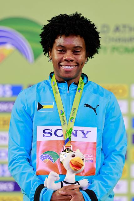 Gold medallist Bahamas' Devynne Charlton celebrates on the podium for the women's 60m hurdles event during the World Athletics Indoor Championships Kujawy Pomorze 2026 in Torun, Poland on March 22, 2026. (Photo by Wojtek RADWANSKI / AFP)