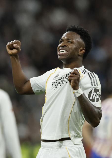 Real Madrid's Brazilian forward #07 Vinicius Junior celebrates scoring his team's third goal during the Spanish league football match between Real Madrid CF and Club Atletico de Madrid at Santiago Bernabeu Stadium in Madrid on March 22, 2026. (Photo by Oscar DEL POZO / AFP)