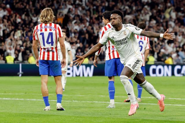 Real Madrid's Brazilian forward #07 Vinicius Junior celebrates scoring his team's third goal during the Spanish league football match between Real Madrid CF and Club Atletico de Madrid at Santiago Bernabeu Stadium in Madrid on March 22, 2026. (Photo by Oscar DEL POZO / AFP)