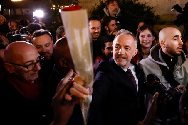 Socialistes et Apparentes' MP and Paris' Mayoral candidate Emmanuel Gregoire picks a rose from a supporter after his victory following the announcement of official results of the second round of France's 2026 municipal elections, at the Rotonde Stalingrad venue in Paris on March 22, 2026. (Photo by Kenzo TRIBOUILLARD / AFP)