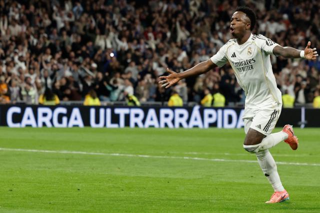 Real Madrid's Brazilian forward #07 Vinicius Junior celebrates scoring his team's third goal during the Spanish league football match between Real Madrid CF and Club Atletico de Madrid at Santiago Bernabeu Stadium in Madrid on March 22, 2026. (Photo by Oscar DEL POZO / AFP)