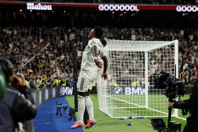 Real Madrid's Brazilian forward #07 Vinicius Junior celebrates scoring his team's third goal during the Spanish league football match between Real Madrid CF and Club Atletico de Madrid at Santiago Bernabeu Stadium in Madrid on March 22, 2026. (Photo by Oscar DEL POZO / AFP)