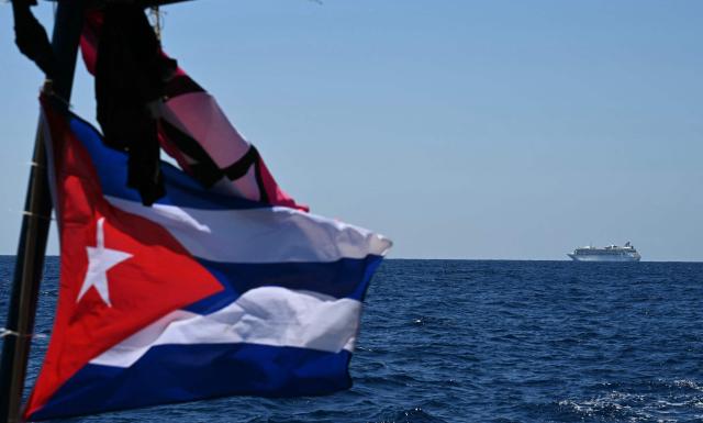 A cruise is pictured from a boat part of the Convoy with 30 tons of humanitarian aid bound for Cuba, organized by left-wing activists from several countries in the Americas and Europe, in the Caribbean Sea on March 22, 2026. (Photo by YURI CORTEZ / AFP)