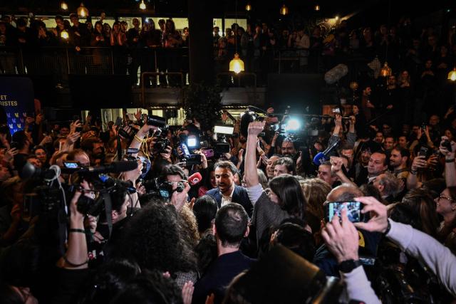Incumbent mayor of Lyon and Europe-Ecology The Greens (EELV) party candidate for re-election Gregory Doucet (C) celebrates as he arrives to deliver a speech during the party rally after he was re-elected in the second round of France's 2026 municipal elections in Lyon, central eastern France on March 22, 2026. (Photo by JEFF PACHOUD / AFP)