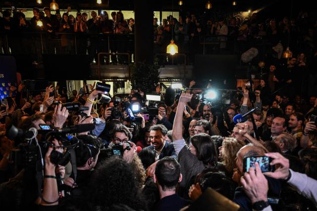 Incumbent mayor of Lyon and Europe-Ecology The Greens (EELV) party candidate for re-election Gregory Doucet (C) celebrates as he arrives to deliver a speech during the party rally after he was re-elected in the second round of France's 2026 municipal elections in Lyon, central eastern France on March 22, 2026. (Photo by JEFF PACHOUD / AFP)