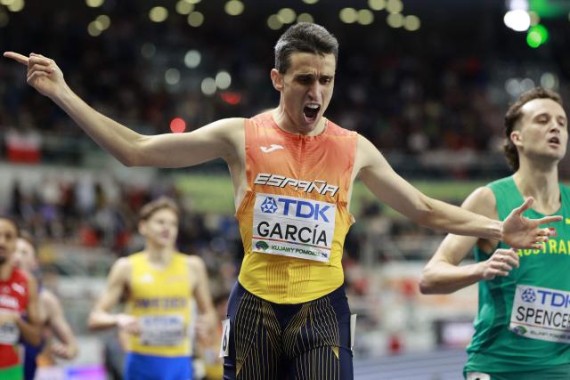 Spain's Mariano García (C) celebrates as he crosses the finish line to win the men's final 1500 metres event during the World Athletics Indoor Championships Kujawy Pomorze 2026 in Torun, Poland on March 22, 2026. (Photo by Wojtek RADWANSKI / AFP)