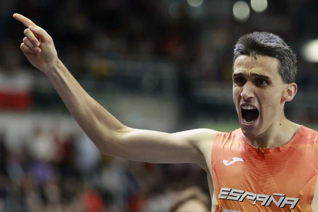 Spain's Mariano García (C) celebrates as he crosses the finish line to win the men's final 1500 metres event during the World Athletics Indoor Championships Kujawy Pomorze 2026 in Torun, Poland on March 22, 2026. (Photo by Wojtek RADWANSKI / AFP)