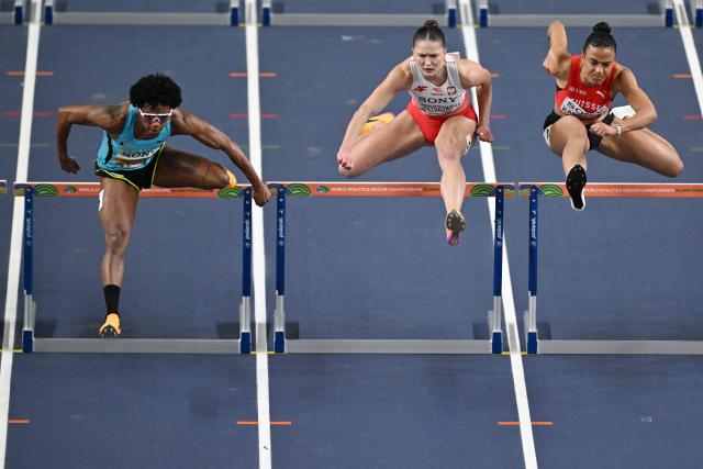 Bahamas' Devynne Charlton (L) competes ahead of Poland's Pia Skrzyszowska (C) and Switzerland's Ditaji Kambundji in the women's final 60 metres hurdles event during the World Athletics Indoor Championships Kujawy Pomorze 2026 in Torun, Poland on March 22, 2026. (Photo by Andrej ISAKOVIC / AFP)
