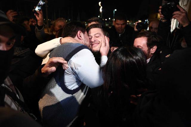 TOPSHOT - Marseille's incumbent mayor and broad left-wing coalition Printemps Marseillais candidate for re-election Benoit Payan celebrates with French anti-drug activist and electoral candidate Amine Kessaci after winning the second round of France's 2026 municipal elections in a bar in Marseille, southern France on March 22, 2026. (Photo by Thibaud MORITZ / AFP)