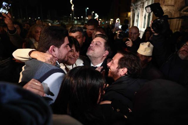 Marseille's incumbent mayor and broad left-wing coalition Printemps Marseillais candidate for re-election Benoit Payan celebrates with French anti-drug activist and electoral candidate Amine Kessaci (L) after winning the second round of France's 2026 municipal elections in Marseille, southern France on March 22, 2026. (Photo by Thibaud MORITZ / AFP)