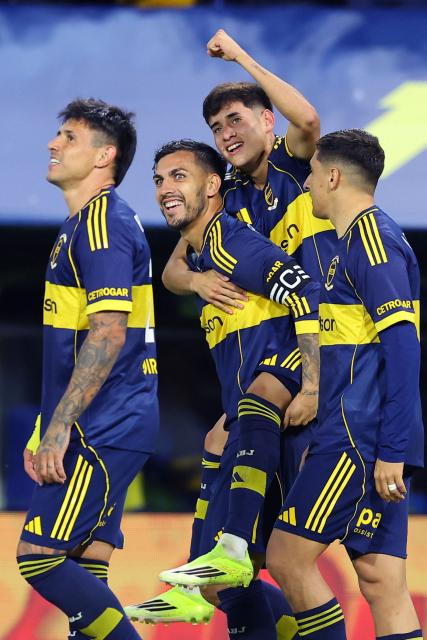Boca Juniors' midfielder #36 Tomas Aranda (C, top) celebrates with teammates midfielder #05 Leandro Paredes (C), Uruguayan forward #16 Miguel Merentiel (R) and Paraguayan forward #28 Adam Bareiro after scoring his team's first goal during the Argentine Professional Football League 2026 Apertura Tournament match between Boca Juniors and Instituto de Cordoba at La Bombonera Stadium in Buenos Aires on March 22, 2026. (Photo by ALEJANDRO PAGNI / AFP)