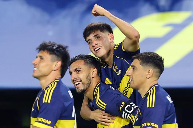Boca Juniors' midfielder #36 Tomas Aranda (C, top) celebrates with teammates midfielder #05 Leandro Paredes (C), Uruguayan forward #16 Miguel Merentiel (R) and Paraguayan forward #28 Adam Bareiro after scoring his team's first goal during the Argentine Professional Football League 2026 Apertura Tournament match between Boca Juniors and Instituto de Cordoba at La Bombonera Stadium in Buenos Aires on March 22, 2026. (Photo by ALEJANDRO PAGNI / AFP)