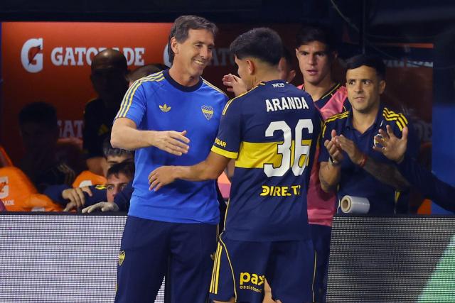 Boca Juniors' head coach Claudio Ubeda embraces Boca Juniors' midfielder #36 Tomas Aranda after his substitution during the Argentine Professional Football League 2026 Apertura Tournament match between Boca Juniors and Instituto de Cordoba at La Bombonera Stadium in Buenos Aires on March 22, 2026. (Photo by ALEJANDRO PAGNI / AFP)