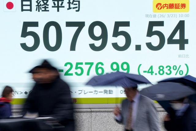 An electronic quotation board displays the Nikkei Stock Average on the Tokyo Stock Exchange along a street in Tokyo on March 23, 2026. (Photo by Kazuhiro NOGI / AFP)