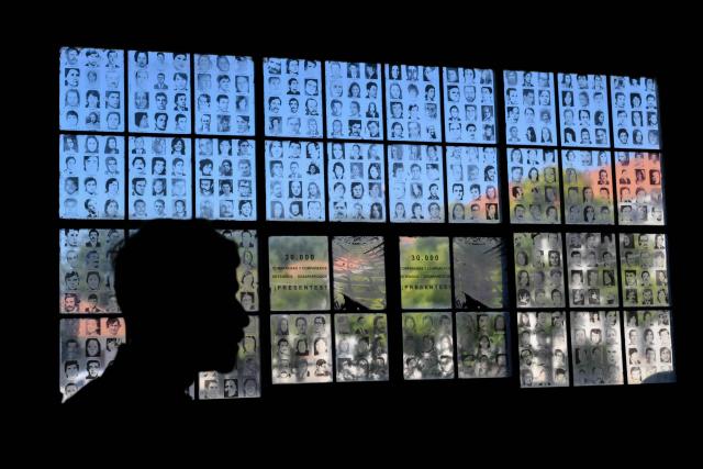 Photos of people who disappeared during the Argentine dictatorship (1976-1983) are displayed at the former clandestine detention center of the Navy School (ESMA) in Buenos Aires on March 18, 2026. Survivors of Argentina's 1976–1983 dictatorship are representatives of a decimated generation whose stories of torture, death and exile come back to life for AFP 50 years after the coup. (Photo by Luis ROBAYO / AFP)
