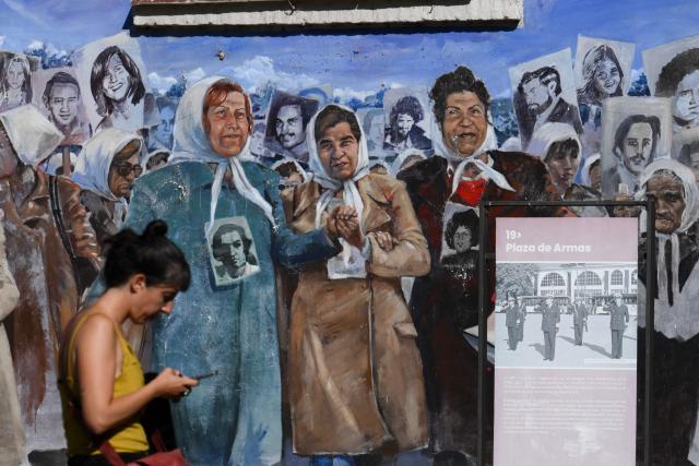 A mural depicting the Mothers and Grandmothers of Plaza de Mayo is seen on the former Naval Mechanics School building at the former clandestine detention center of the Navy School (ESMA), which operated during the Argentine dictatorship (1976-1983), in Buenos Aires on March 18, 2026. Survivors of Argentina's 1976–1983 dictatorship are representatives of a decimated generation whose stories of torture, death and exile come back to life for AFP 50 years after the coup. (Photo by Luis ROBAYO / AFP)
