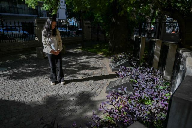 Ana Maria Careaga, who was abducted at the age of 16 while three months pregnant during the military dictatorship (1976-1983), contemplates the tomb of her mother at Santa Cruz church during an interview with AFP in Buenos Aires on March 7, 2026. Survivors of Argentina's 1976–1983 dictatorship are representatives of a decimated generation whose stories of torture, death and exile come back to life for AFP 50 years after the coup. (Photo by Luis ROBAYO / AFP)