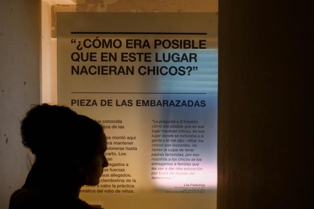A woman visits the room where pregnant detainees gave birth and their babies were then taken and handed over to other families, in the Officers Casino building at the former clandestine detention center of the Navy School (ESMA) during the Argentine dictatorship (1976-1983), in Buenos Aires on March 18, 2026. Survivors of Argentina's 1976–1983 dictatorship are representatives of a decimated generation whose stories of torture, death and exile come back to life for AFP 50 years after the coup. (Photo by Luis ROBAYO / AFP)
