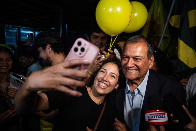 Peru's presidential candidate Jorge Nieto for the Buen Gobierno party, poses for a selfie as he arrives for a campaign event in Lima on March 22, 2026. Peru will hold presidential elections on April 12. (Photo by ERNESTO BENAVIDES / AFP)