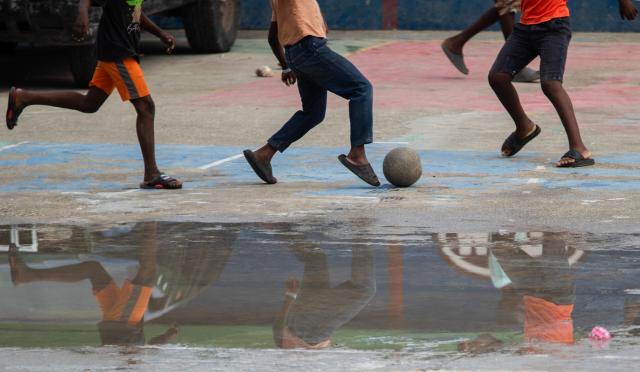 Children play football in Jalouzi, Port-au-Prince, Haiti, on March 21, 2026. (Photo by Clarens SIFFROY / AFP)