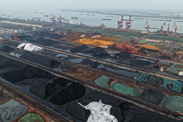 Coal is stored at a coal terminal on the Yangtze river in Nanjing, in China’s eastern Jiangsu province, on March 22, 2026. (Photo by CN-STR / AFP) / China OUT