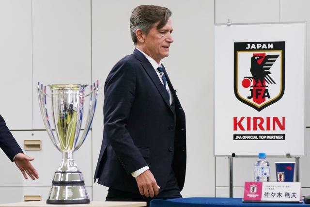Japan women's national football team head coach Nils Nielsen walks past the trophy at the beginning of the press conference following Japan's victory in the AFC Women's Asian Cup Australia 2026 football tournament, in Tokyo on March 23, 2026. (Photo by Kazuhiro NOGI / AFP)