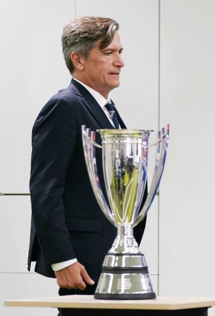 Japan women's national football team head coach Nils Nielsen walks past the trophy at the beginning of a press conference following Japan's victory in the AFC Women's Asian Cup Australia 2026 football tournament, in Tokyo on March 23, 2026. (Photo by Kazuhiro NOGI / AFP)