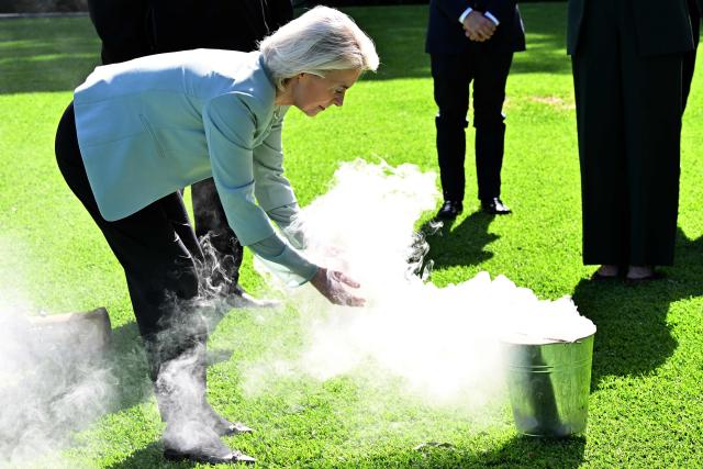 European Commission President Ursula von der Leyen participates in a traditional Aboriginal smoking ceremony during a visit at Admiralty House in Sydney on March 23, 2026. (Photo by Saeed KHAN / AFP)