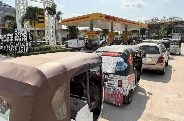 Vehicles queue up at a fuel station in Phnom Penh on March 23, 2026. A major energy supplier in Cambodia has said it will halt sales of liquefied petroleum gas from the start of next month due to supply disruptions resulting from the Middle East war. (Photo by TANG CHHIN Sothy / AFP)