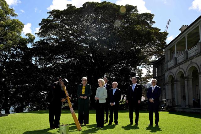 European Commission President Ursula von der Leyen (C) and Australia's Governor-General Sam Mostyn (2nd L) attend a traditional Aboriginal welcome ceremony at Admiralty House in Sydney on March 23, 2026. (Photo by Saeed KHAN / AFP)