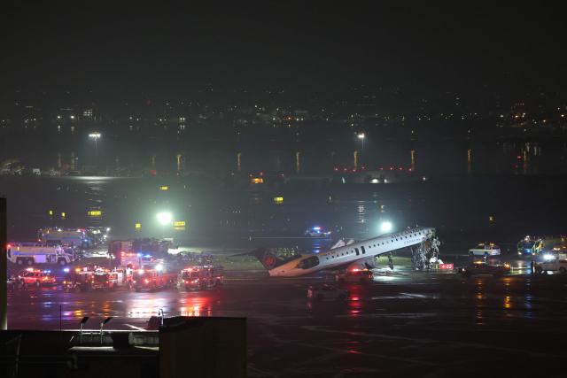 Emergency personnel respond to an Air Canada Express CRJ-900 that is sitting on the runway after colliding with a Port Authority fire truck at LaGuardia Airport in New York, on March 23, 2026. Air Canada Express flight AC8646 originated from Montreal and collided with the fire truck during landing. (Photo by ANGELA WEISS / AFP)