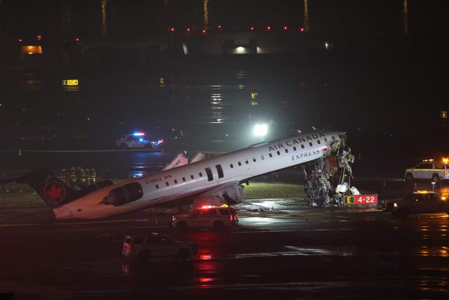 An Air Canada Express CRJ-900 sits on the runway after colliding with a Port Authority fire truck at LaGuardia Airport in New York, on March 23, 2026. Air Canada Express flight AC8646 originated from Montreal and collided with the fire truck during landing. (Photo by ANGELA WEISS / AFP)