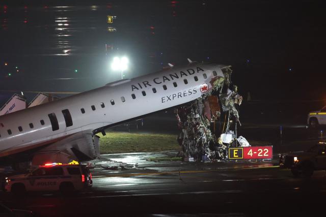 TOPSHOT - An Air Canada Express CRJ-900 sits on the runway after colliding with a Port Authority fire truck at LaGuardia Airport in New York, on March 23, 2026. Air Canada Express flight AC8646 originated from Montreal and collided with the fire truck during landing. (Photo by ANGELA WEISS / AFP)
