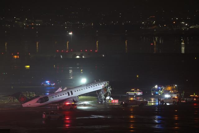 An Air Canada Express CRJ-900 sits on the runway after colliding with a Port Authority fire truck at LaGuardia Airport in New York, on March 23, 2026. Air Canada Express flight AC8646 originated from Montreal and collided with the fire truck during landing. (Photo by ANGELA WEISS / AFP)