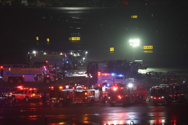 Emergency personnel respond to an Air Canada Express CRJ-900 after colliding with a Port Authority fire truck at LaGuardia Airport in New York, on March 23, 2026. Air Canada Express flight AC8646 originated from Montreal and collided with the fire truck during landing. (Photo by ANGELA WEISS / AFP)