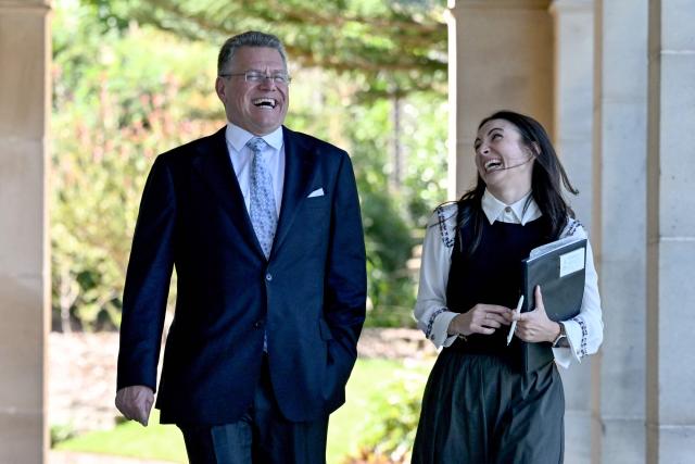 EU Trade Commissioner Maros Sefcovic (L) walks through the colonnaded verandah at Admiralty House in Sydney on March 23, 2026, during the visit of European Commission President Ursula von der Leyen. (Photo by Saeed KHAN / AFP)