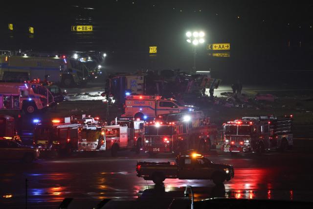 Emergency personnel respond to an Air Canada Express CRJ-900 after colliding with a Port Authority fire truck at LaGuardia Airport in New York, on March 23, 2026. Air Canada Express flight AC8646 originated from Montreal and collided with the fire truck during landing. (Photo by ANGELA WEISS / AFP)