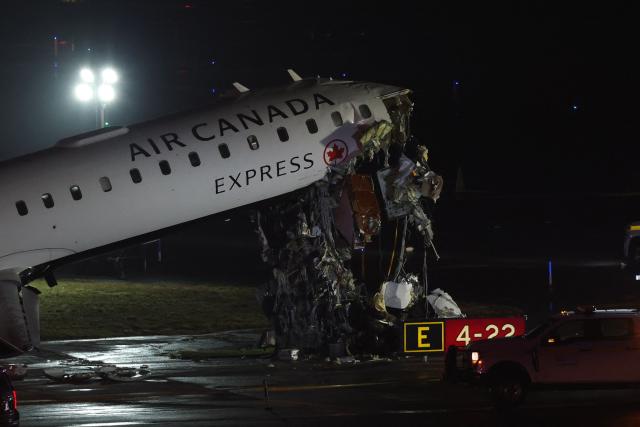 An Air Canada Express CRJ-900 sits on the runway after colliding with a Port Authority fire truck at LaGuardia Airport in New York, on March 23, 2026. Air Canada Express flight AC8646 originated from Montreal and collided with the fire truck during landing. (Photo by ANGELA WEISS / AFP)