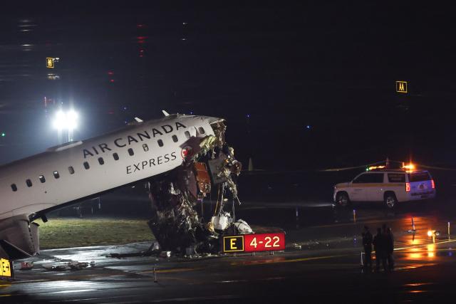 An Air Canada Express CRJ-900 sits on the runway after colliding with a Port Authority fire truck at LaGuardia Airport in New York, on March 23, 2026. Air Canada Express flight AC8646 originated from Montreal and collided with the fire truck during landing. (Photo by ANGELA WEISS / AFP)