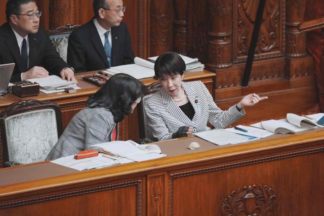 Japan's Prime Minister Sanae Takaichi (front R) chats with Finance Minister Satsuki Katayama (front L) during a plenary session of the House of Councillors at Parliament in Tokyo on March 23, 2026. (Photo by Kazuhiro NOGI / AFP)