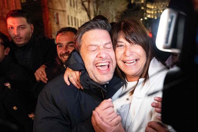 Marseille's incumbent mayor and broad left-wing coalition Printemps Marseillais candidate for re-election Benoit Payan (C) flanked by Marseille's outgoing deputy mayor Michele Rubirola (R) celebrates with supporters after winning the second round of France's 2026 municipal elections in Marseille, southern France on March 22, 2026. (Photo by Elodie CLEMENT / AFP)